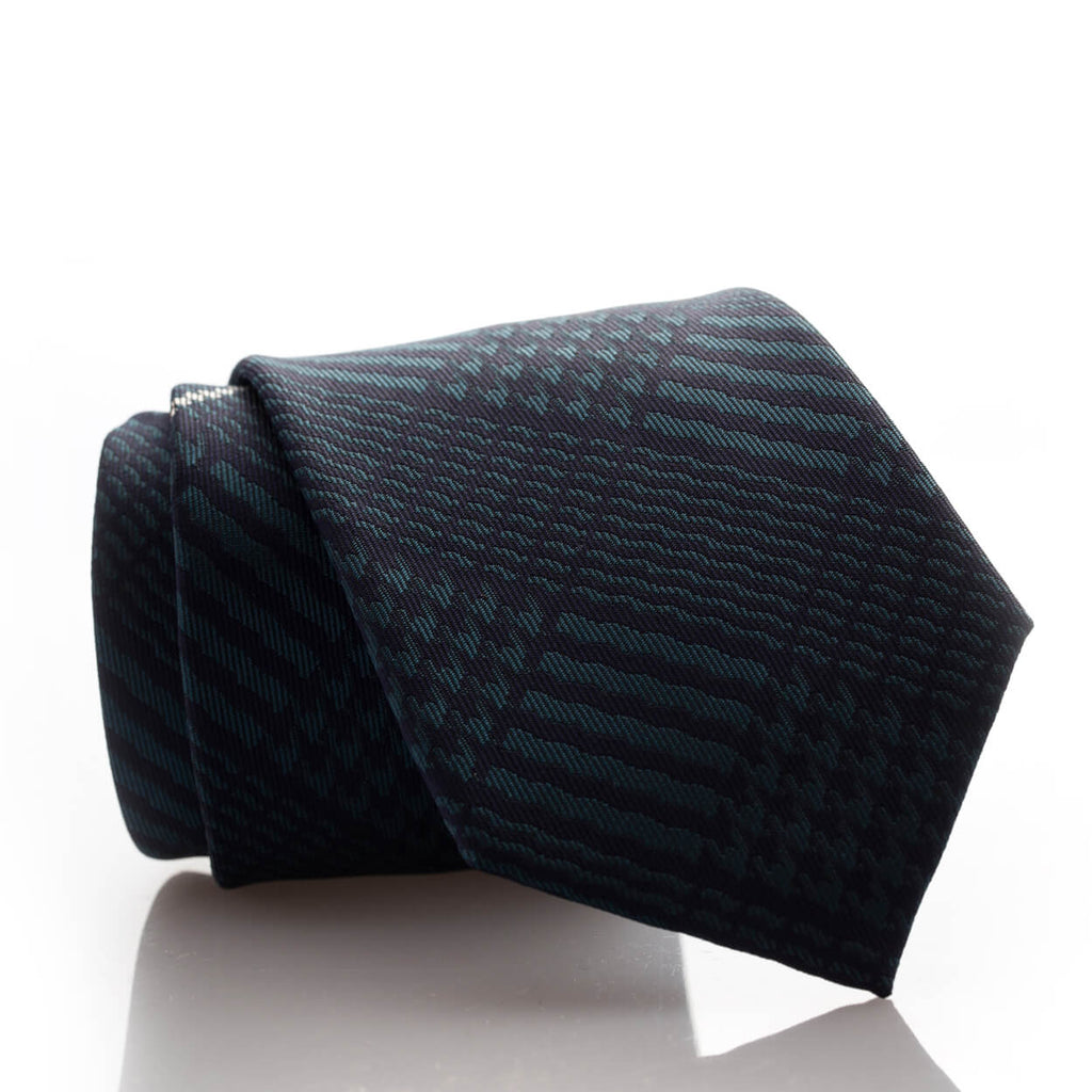 A dark green tie with a black and white pattern, perfect for adding a touch of sophistication to any outfit.