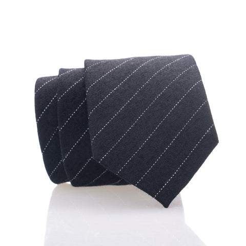 A black tie with white stripes, suitable for formal occasions.